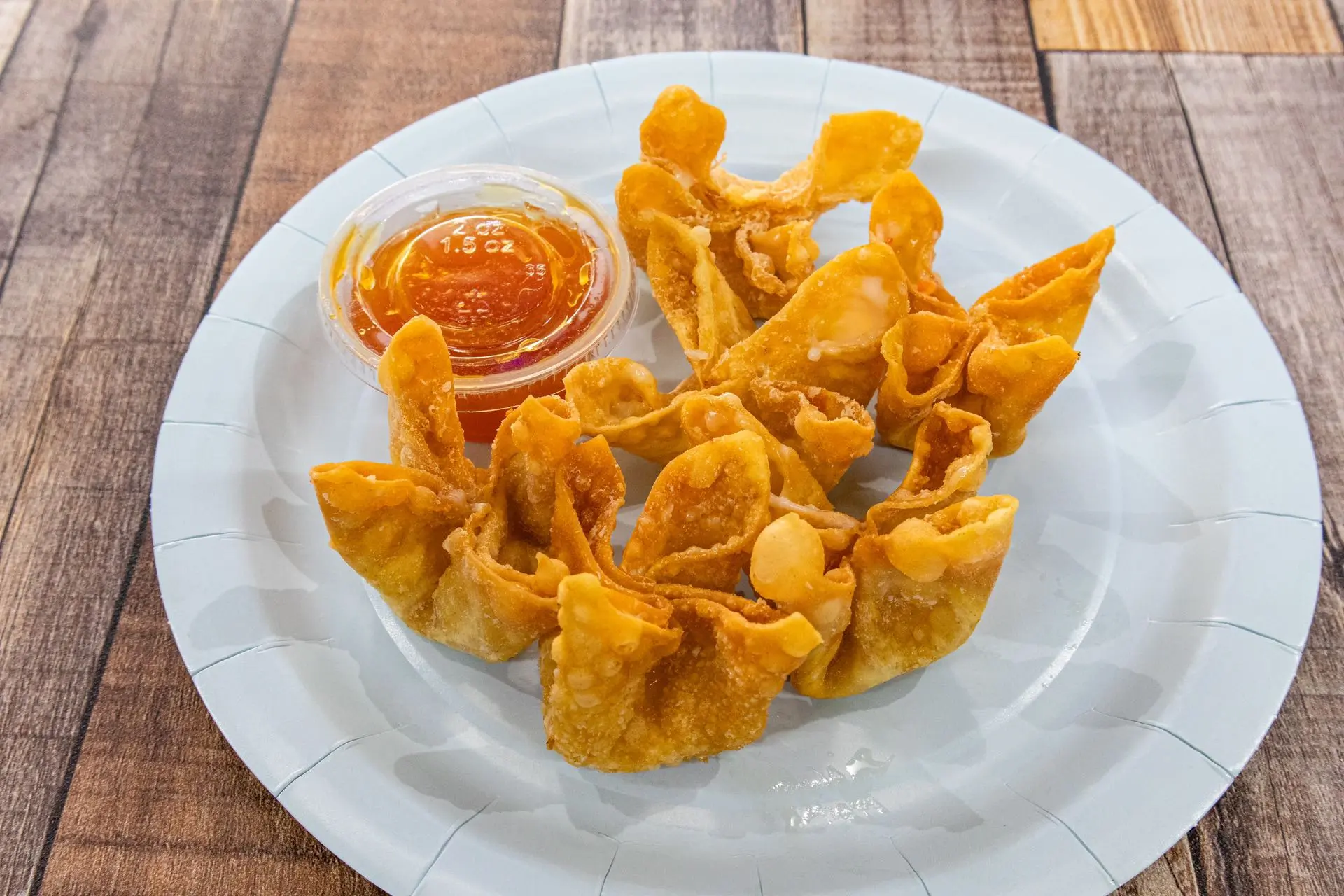 Fried crab rangoon with sweet dipping sauce at Aaron Wings & Hibachi, a Hibachi & Wings Restaurant in Stockbridge