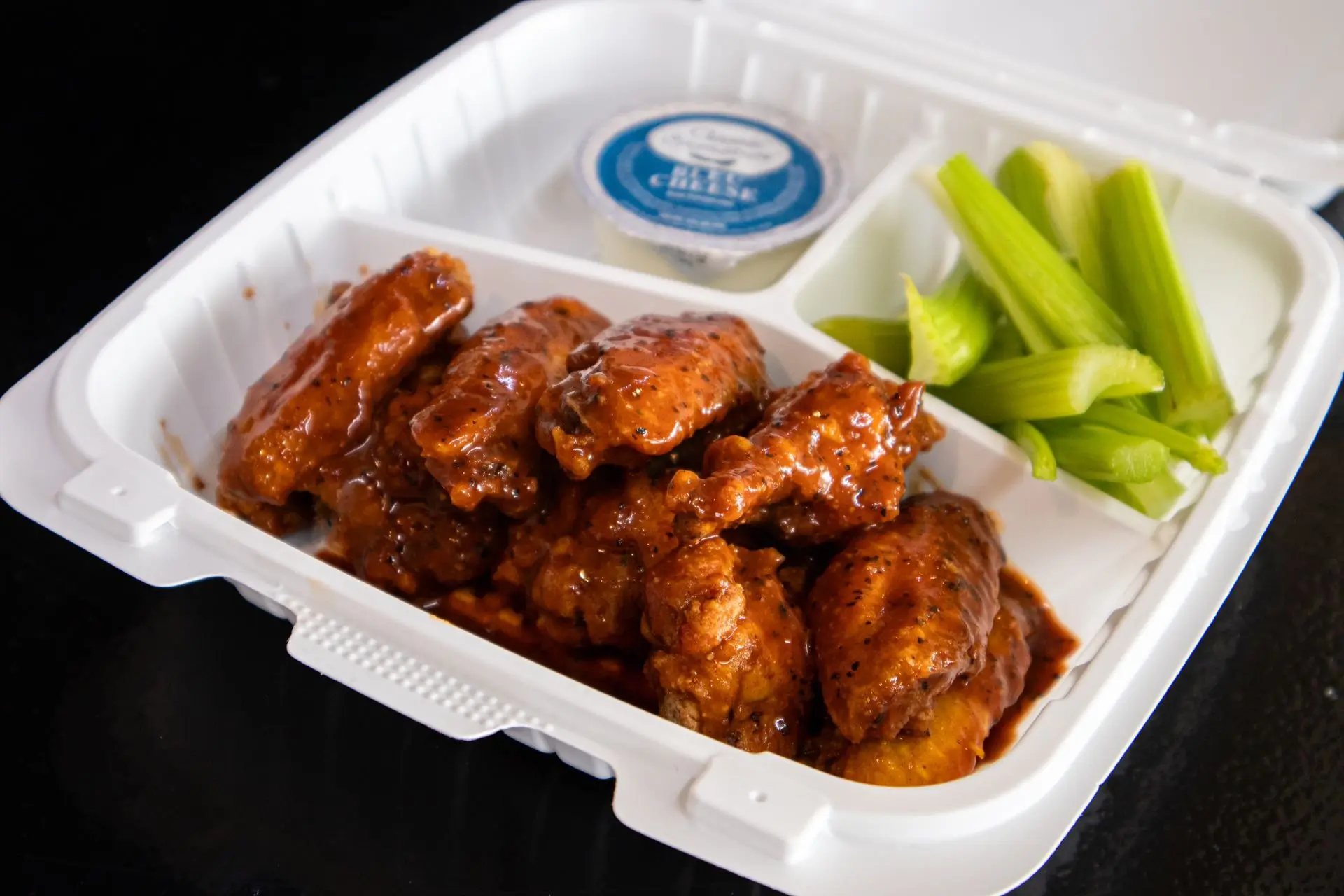 BBQ buffalo wings with celery and blue cheese dip at Aaron Wings & Hibachi, a Hibachi & Wings Restaurant in Stockbridge