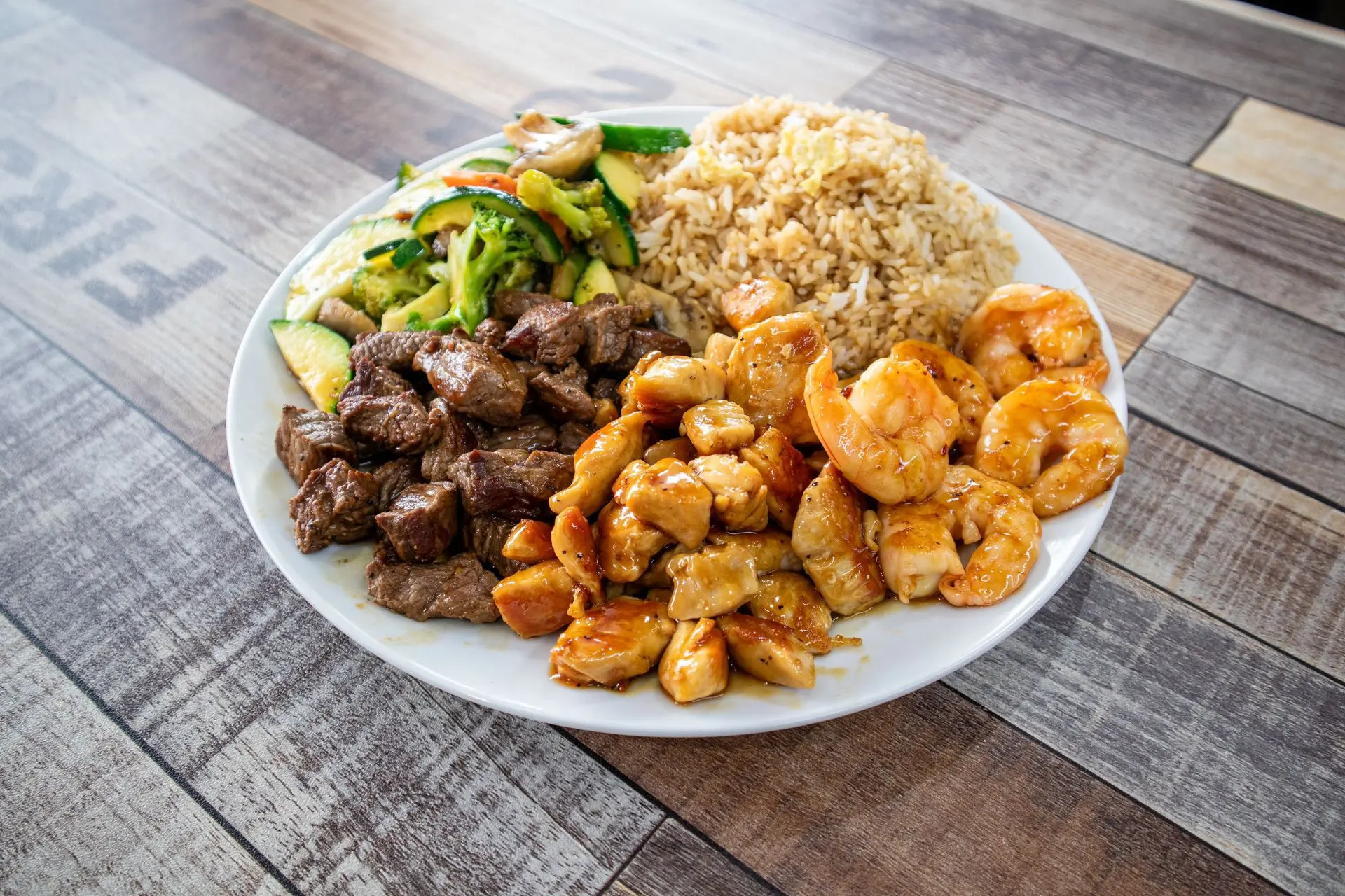 Hibachi combo plate with steak chicken shrimp rice and veggies at Aaron Wings & Hibachi, a Hibachi & Wings Restaurant in Stockbridge