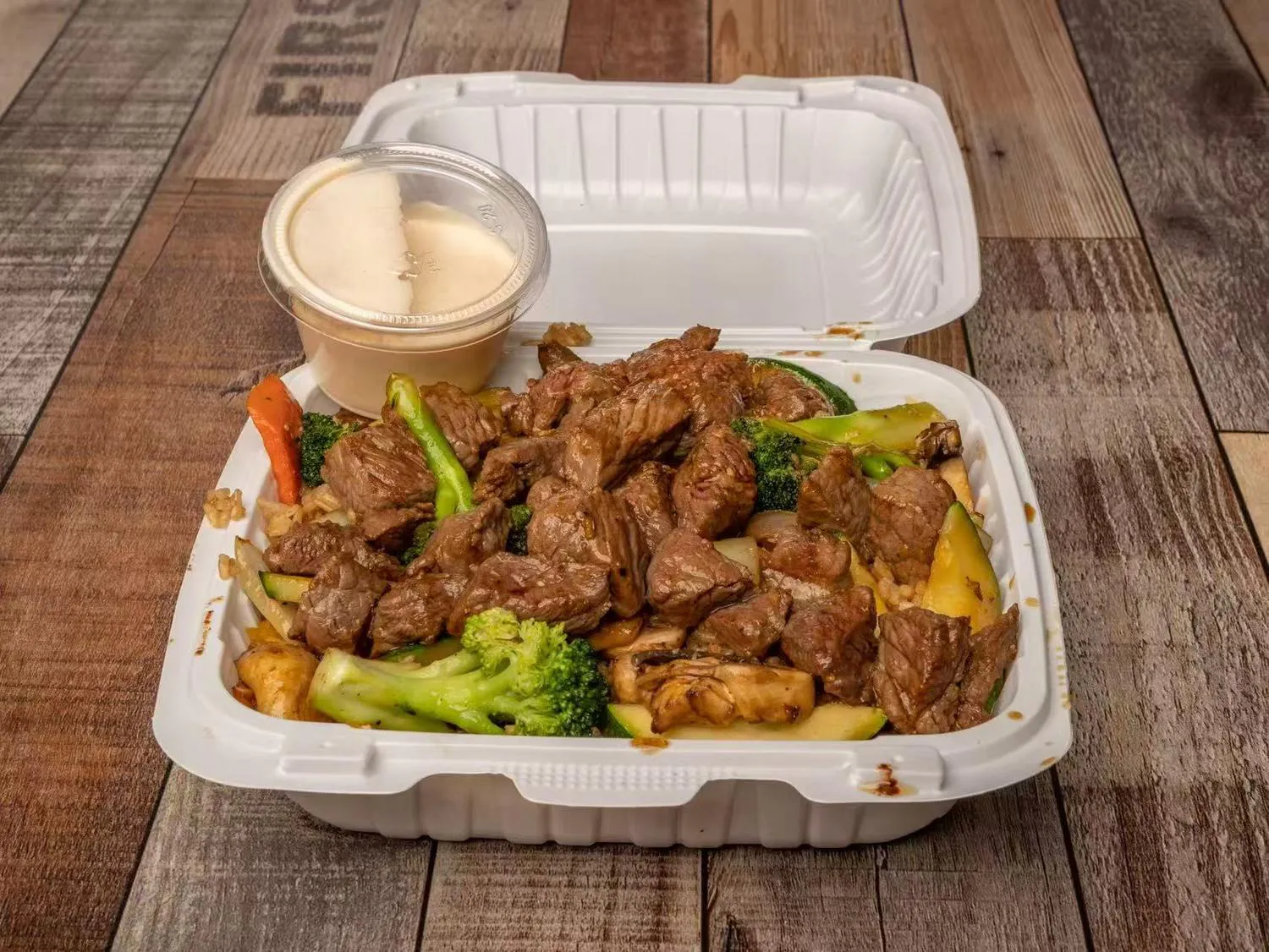Grilled steak hibachi with mixed vegetables and house sauce to go at Aaron Wings & Hibachi, a Hibachi & Wings Restaurant in Stockbridge
